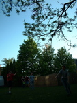 After getting 2nd frisbee dislodged, Other tries using string & plumb bob to get first one down.