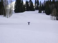 Carla tries to make herself bigger to scare off other skiers