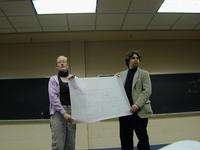 A blueprint is flashed at the audience